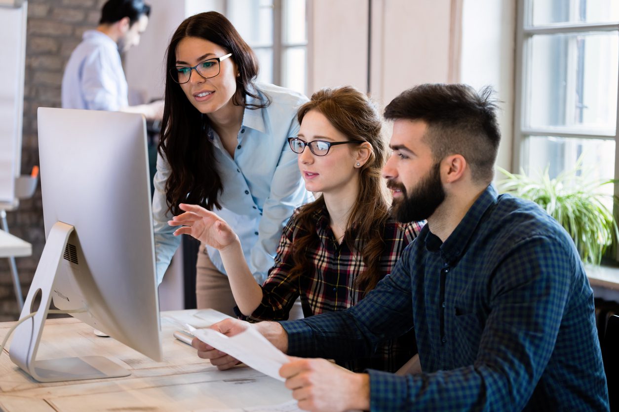 Young architects working on project in office together